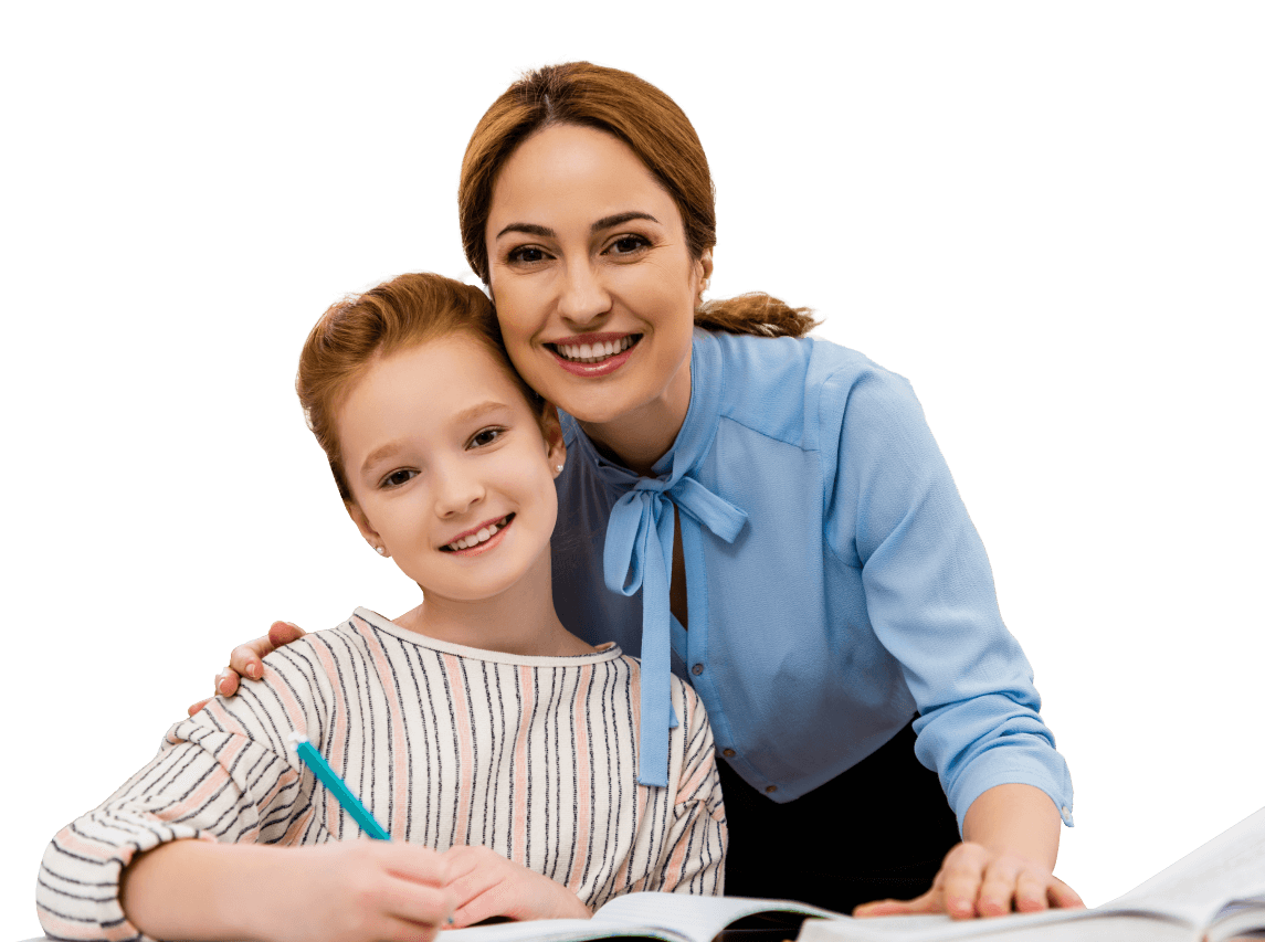 A smiling woman with her arm around a young girl who is holding a pen and writing in a notebook.